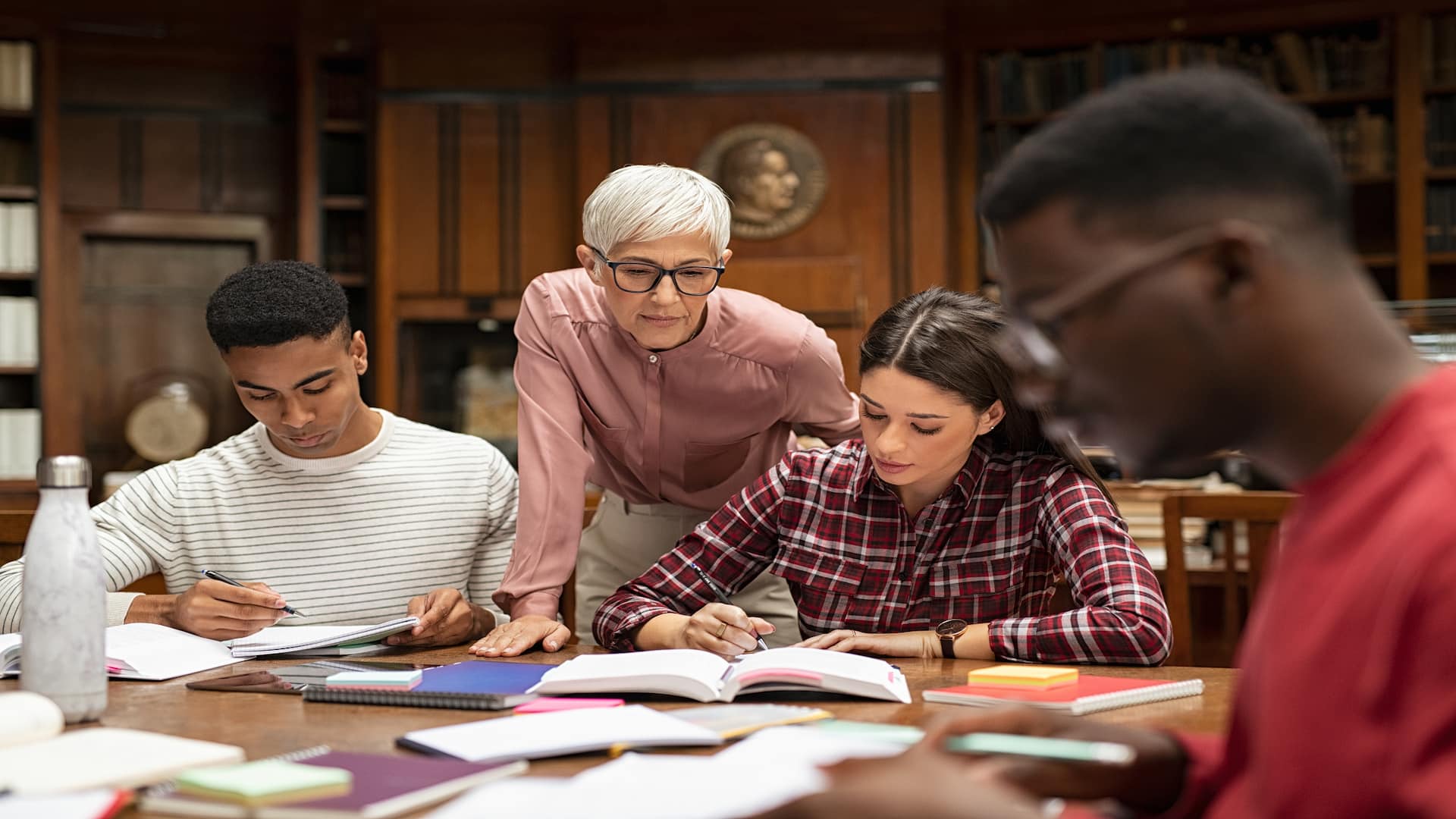 university-students-studying-with-teacher